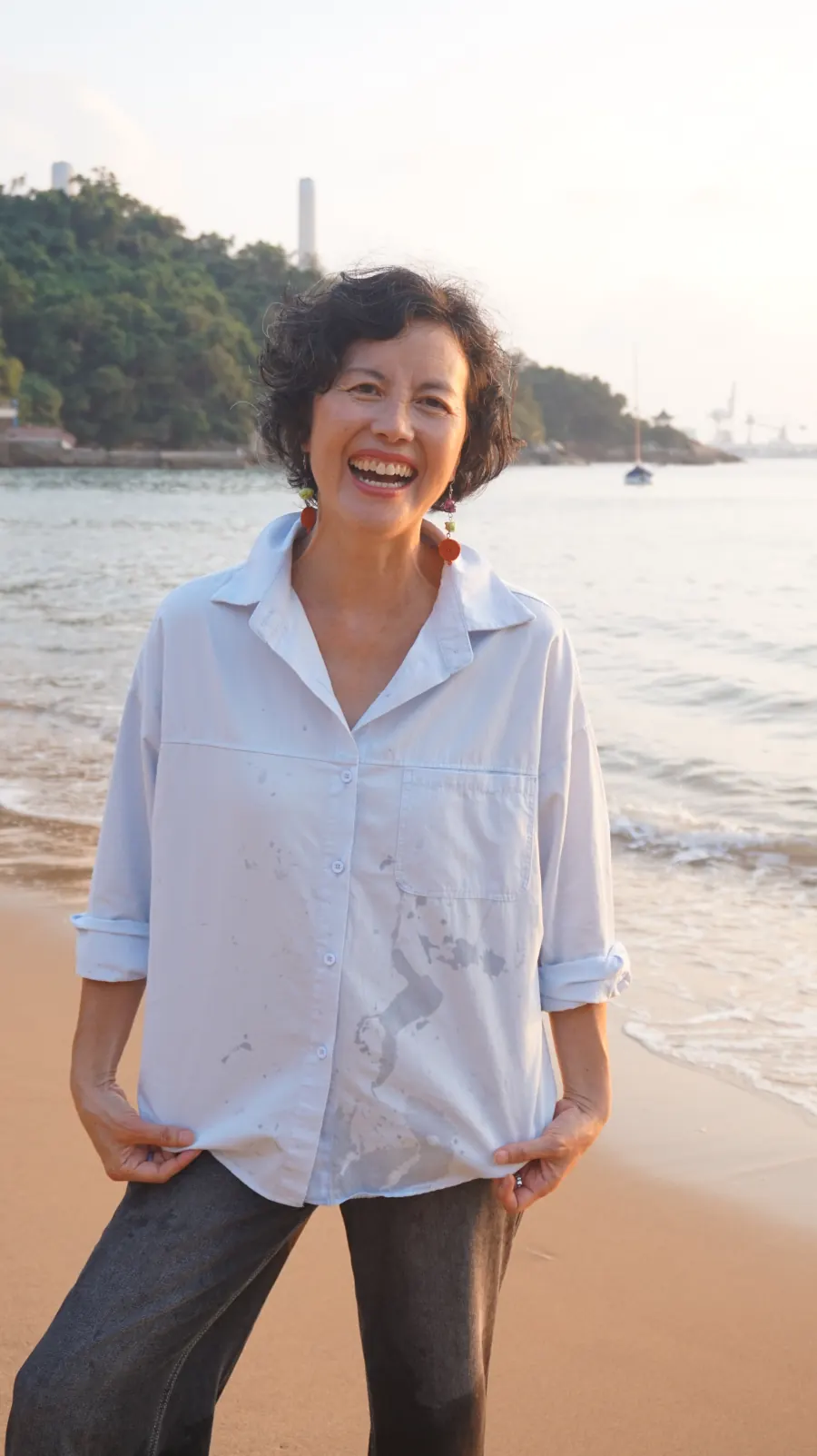 Pauline Goh laughing on the beach on Lamma Island, Hong Kong